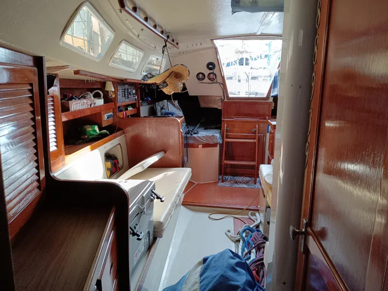 Slide: The Image of Interior of a 1985 Catalina 38 sailboat, featuring wooden cabinetry and nautical equipment. - 7