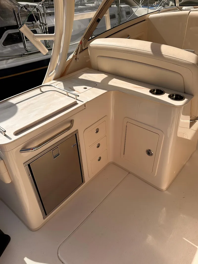 Slide: The Image of 2019 Grady-White Freedom 325 boat interior with kitchenette and storage compartments. - 10