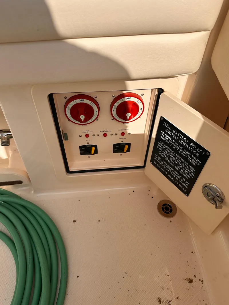 Slide: The Image of 2019 Grady-White Freedom 325 boat control panel with switches and hose. - 11