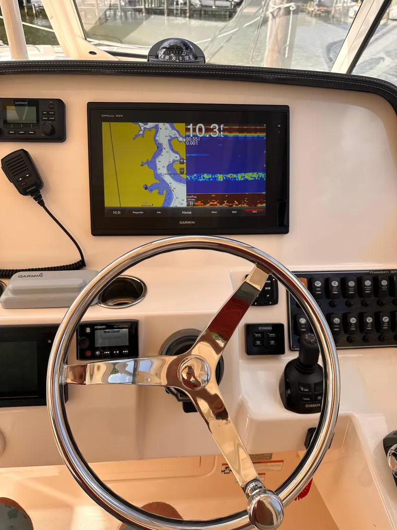 Slide: The Image of 2019 Grady-White Freedom 325 helm with navigation display and controls. - 4