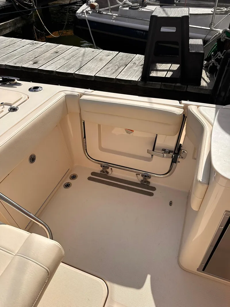 Slide: The Image of 2019 Grady-White Freedom 325 boat interior with open transom door. - 8