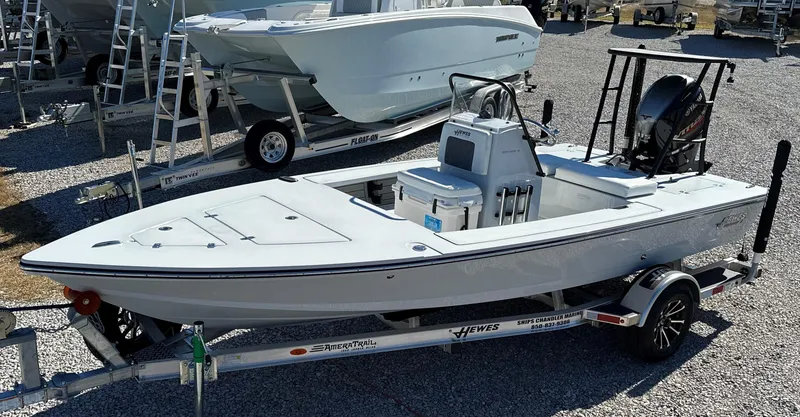 Slide: The Image of 2024 Hewes 18 Redfisher boat on a trailer in a dealership lot. - 10