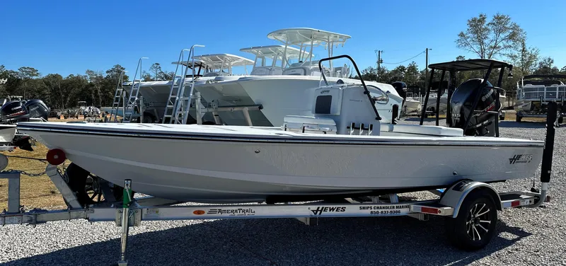 Slide: The Image of 2024 Hewes 18 Redfisher boat on a trailer in a marina. - 4