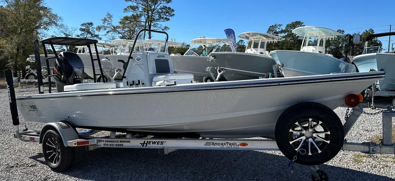 Slide: The Image of 2024 Hewes 18 Redfisher boat on trailer in outdoor showroom. - 6