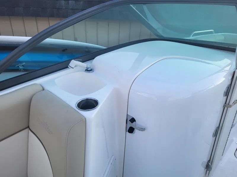 Slide: The Image of 2020 NauticStar 223DC Sport Deck interior with seating and cup holder. - 11