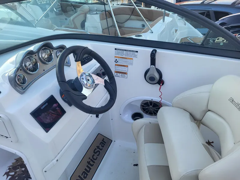 Slide: The Image of 2020 NauticStar 223DC Sport Deck boat cockpit with steering wheel and control panel. - 8