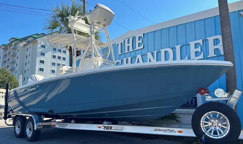 The Image of 2025 Pathfinder 2400 Open boat on trailer, parked near a blue building. - 0