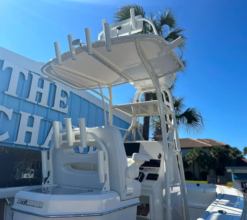 Slide: The Image of 2025 Pathfinder 2400 Open boat with T-top and rod holders, sunny day. - 10