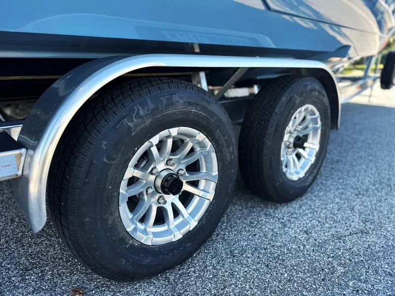 Slide: The Image of 2025 Pathfinder 2400 Open trailer wheels on asphalt. - 12