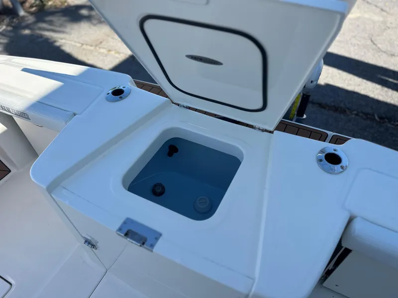 Slide: The Image of Pathfinder 2400 Open 2025 boat livewell with open lid, showcasing interior features. - 15