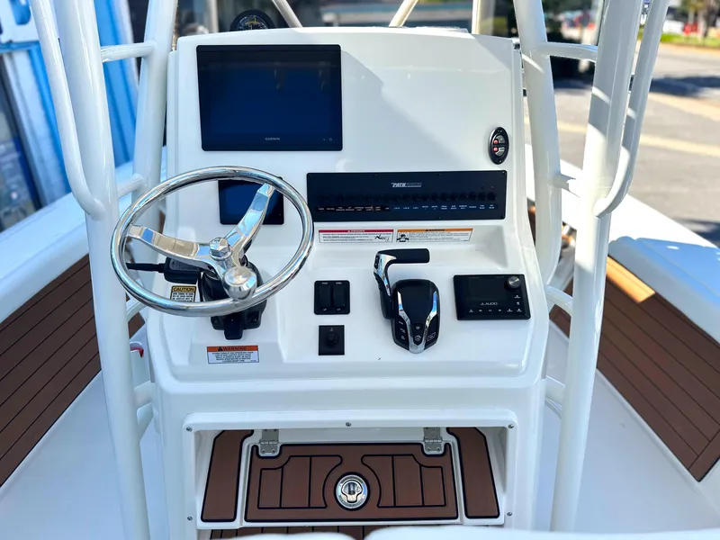 Slide: The Image of 2025 Pathfinder 2400 Open boat console with steering wheel and controls. - 17
