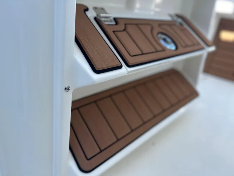 Slide: The Image of 2025 Pathfinder 2400 Open boat interior with brown cushioned seating. - 19