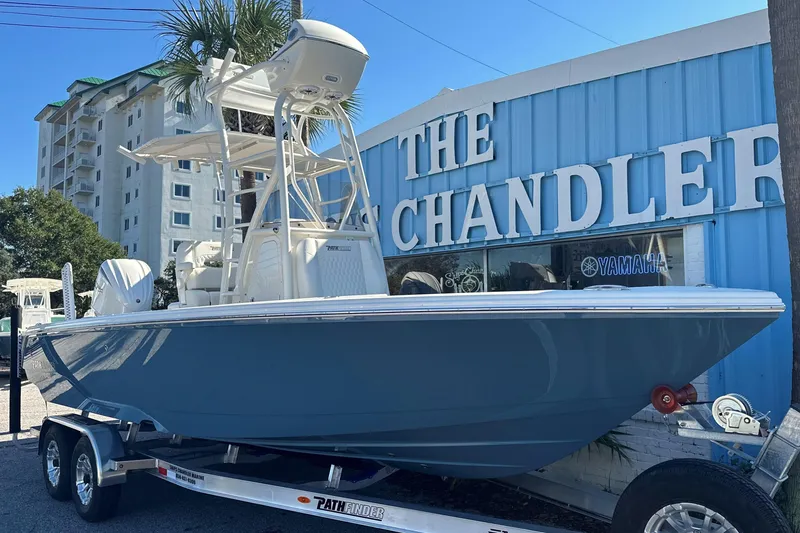 Slide: The Image of 2025 Pathfinder 2400 Open boat on trailer outside The Chandler building. - 2