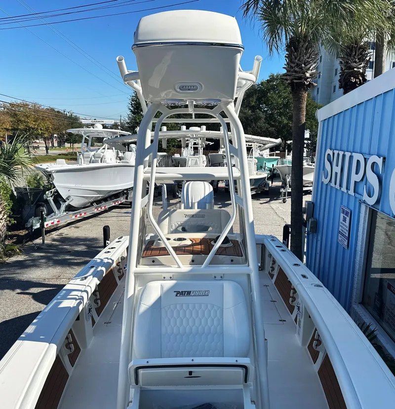 Slide: The Image of 2025 Pathfinder 2400 Open boat displayed outdoors near a blue building. - 23