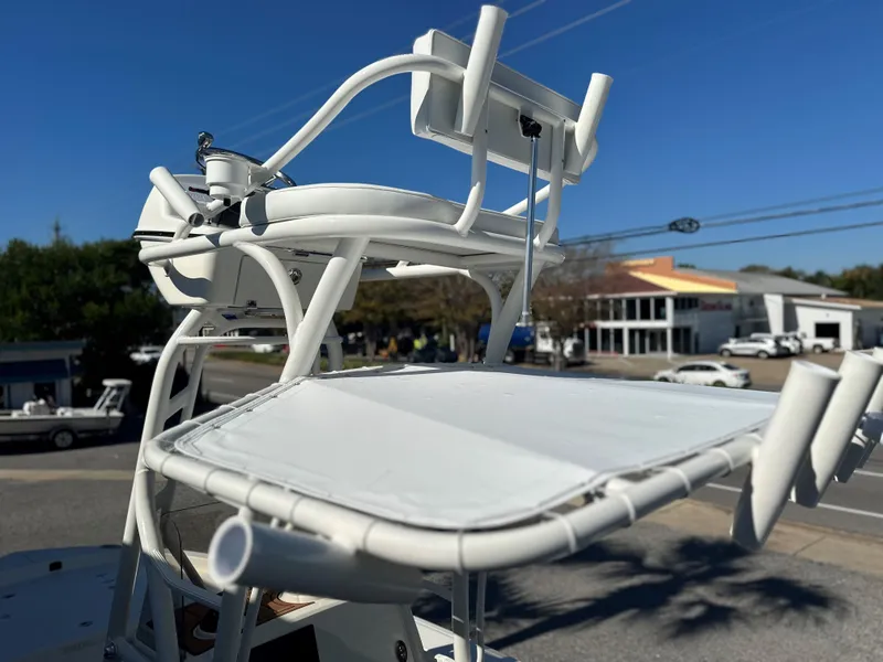Slide: The Image of Pathfinder 2400 Open 2025 boat tower with rod holders and seating, street view background. - 28