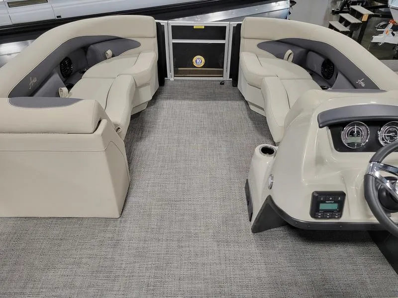 Slide: The Image of 2024 Barletta Aria A22CC boat interior with plush seating and modern dashboard. - 10