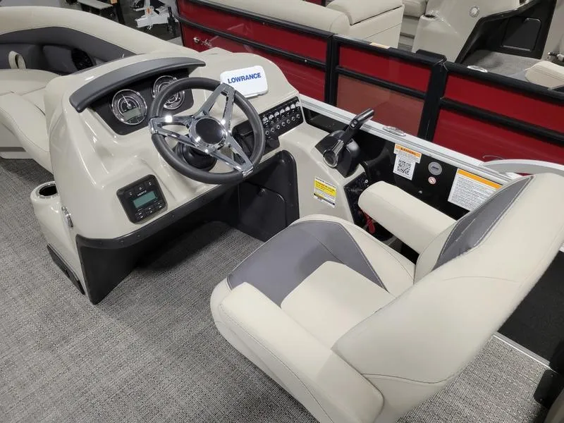 Slide: The Image of 2024 Barletta Aria A22CC boat interior with steering wheel and control panel. - 11