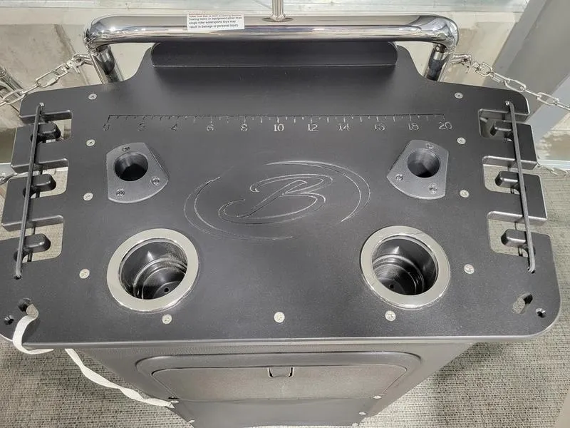 Slide: The Image of 2024 Barletta Aria A22CC boat console with cup holders and measurement markings. - 17