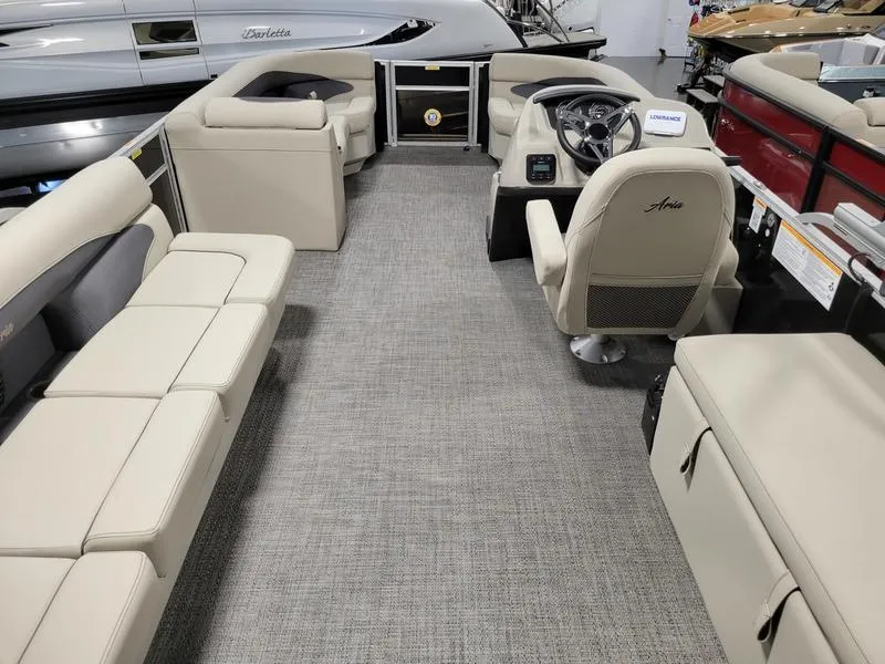 Slide: The Image of 2024 Barletta Aria A22CC pontoon boat interior with beige seating and modern helm. - 18