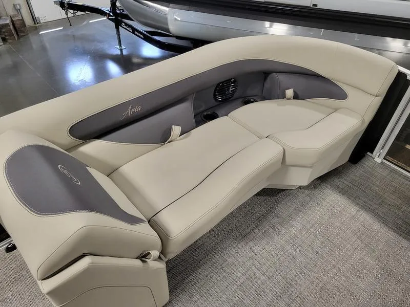Slide: The Image of 2024 Barletta Aria A22CC boat seating, beige and gray upholstery, indoor showroom display. - 5