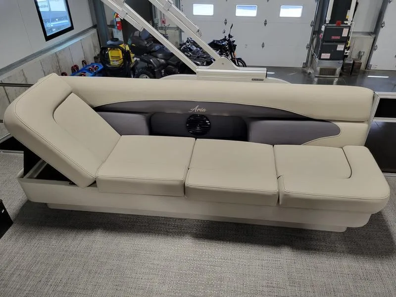 Slide: The Image of 2024 Barletta Aria A22CC boat interior with beige seating in a showroom. - 7