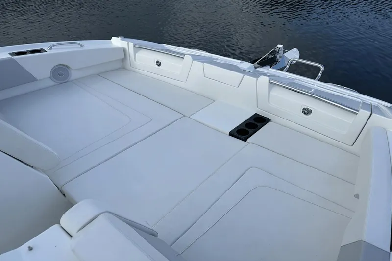 Slide: The Image of Spacious seating area on the 2023 Aquila 32 Sport boat with cup holders and storage compartments. - 10