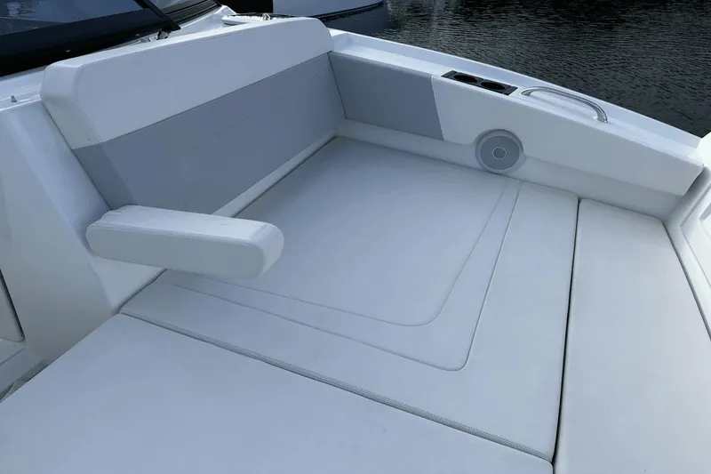 Slide: The Image of Aquila 32 Sport 2023 boat interior with white cushioned seating and armrest. - 11