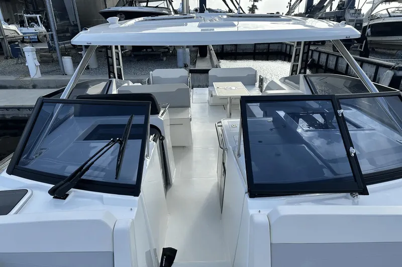 Slide: The Image of 2023 Aquila 32 Sport boat interior with seating and windshield. - 12
