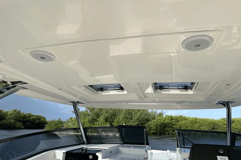 Slide: The Image of 2023 Aquila 32 Sport boat interior with roof hatches and speakers. - 13