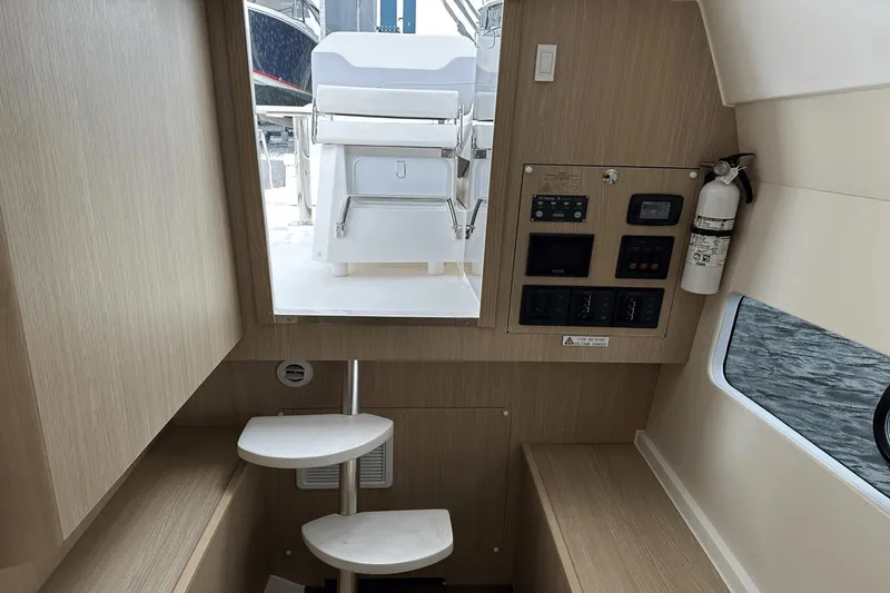 Slide: The Image of Interior of 2023 Aquila 32 Sport boat with control panel and stairs. - 23