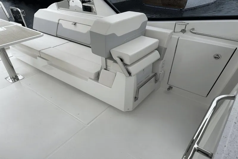 Slide: The Image of Interior seating area of 2023 Aquila 32 Sport boat with white and gray upholstery. - 24