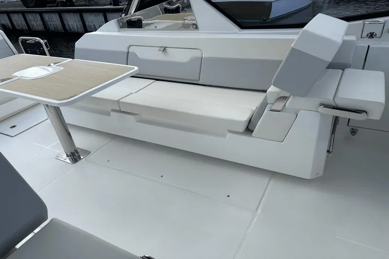 Slide: The Image of Interior seating and table of 2023 Aquila 32 Sport boat. - 25