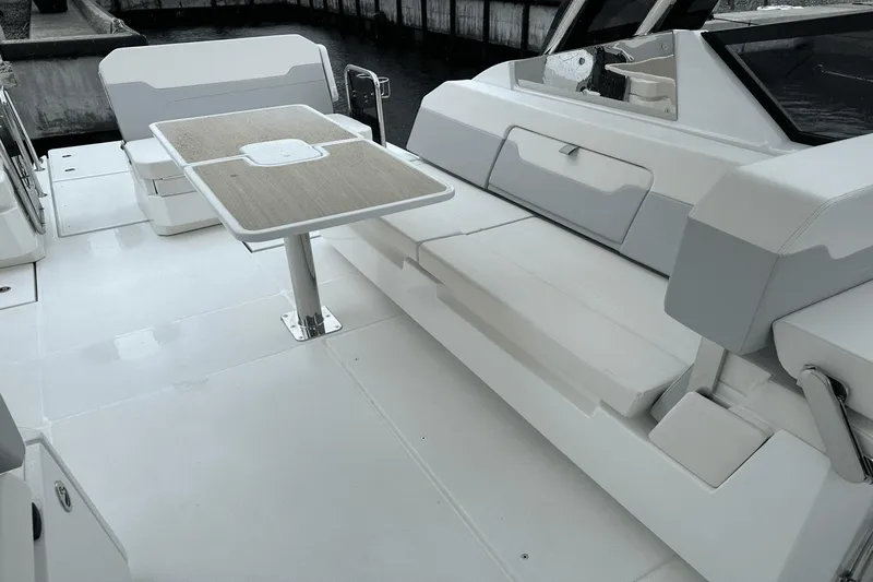 Slide: The Image of 2023 Aquila 32 Sport boat interior with seating and table. - 26