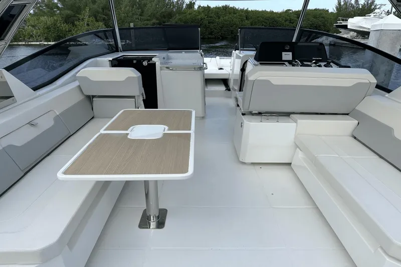 Slide: The Image of Interior of 2023 Aquila 32 Sport boat with seating and table setup. - 29