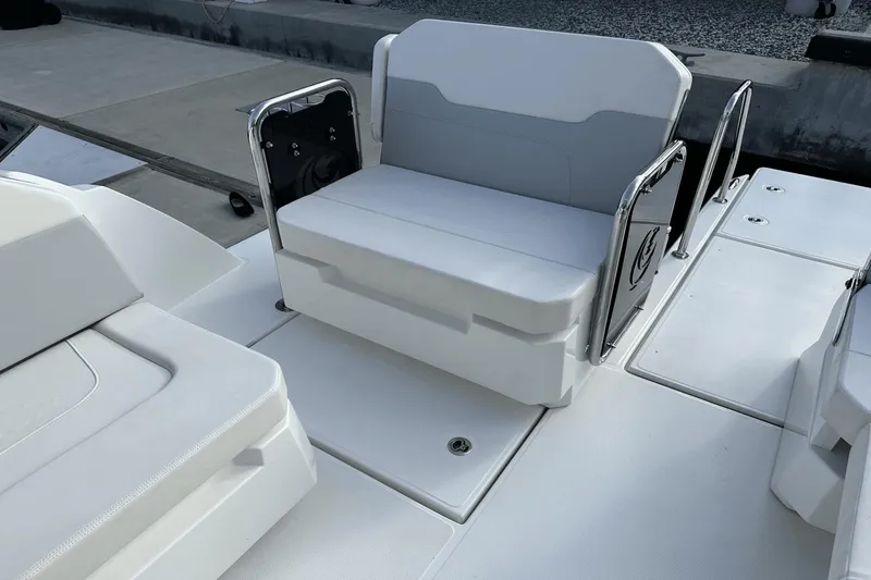 Slide: The Image of Aquila 32 Sport 2023 boat seating area with white cushioned seats and stainless steel railings. - 31