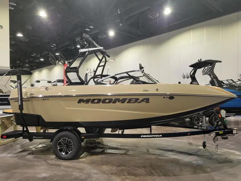 Slide: The Image of 2024 Moomba Mondo boat on display in an indoor showroom. - 1