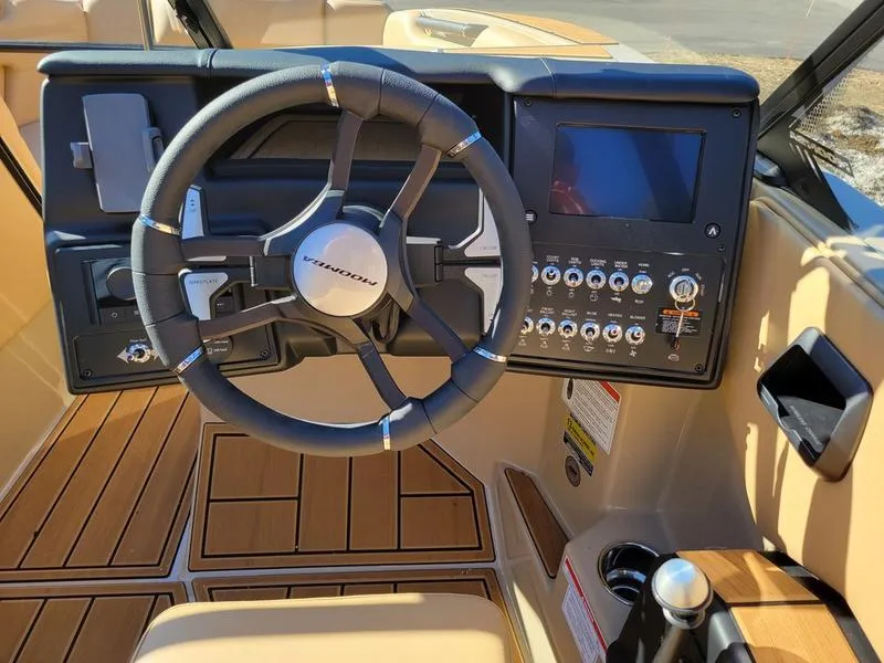 Slide: The Image of 2024 Moomba Mondo boat dashboard with steering wheel and control panel. - 12