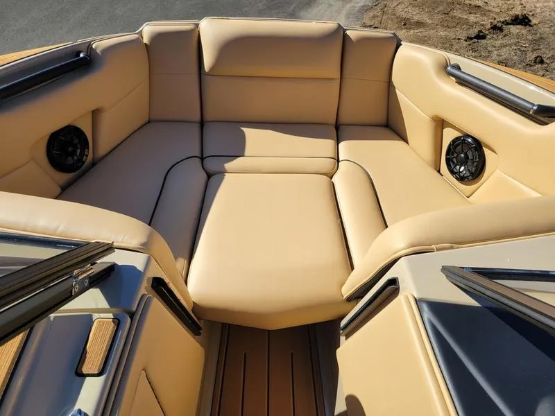 Slide: The Image of 2024 Moomba Mondo boat interior with tan leather seating and built-in speakers. - 18