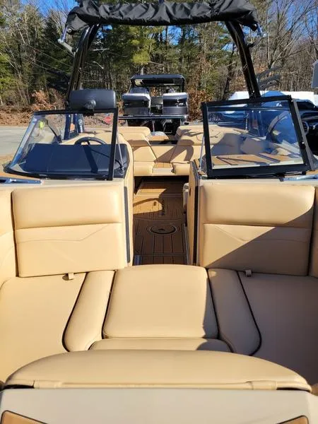 Slide: The Image of 2024 Moomba Mondo boat interior with tan leather seats and open deck. - 22