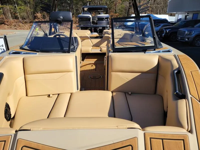 Slide: The Image of 2024 Moomba Mondo boat interior with tan leather seats and open deck. - 33