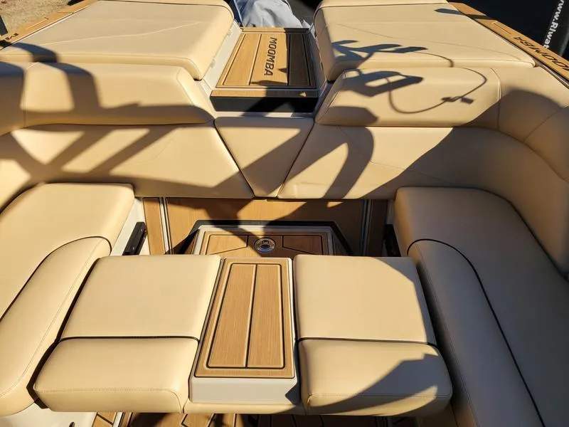 Slide: The Image of 2024 Moomba Mondo boat interior with beige seating and wooden accents. - 36