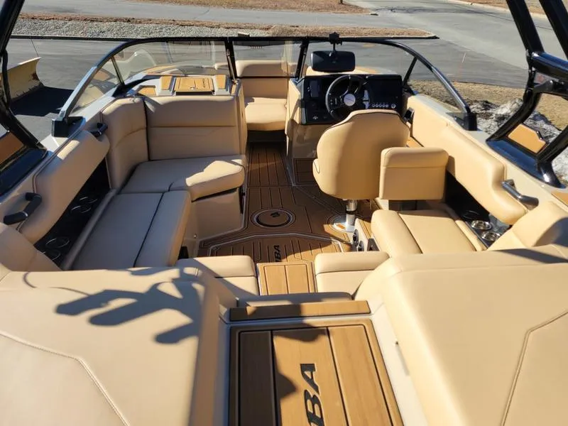 Slide: The Image of 2024 Moomba Mondo boat interior with beige seating and modern dashboard. - 5