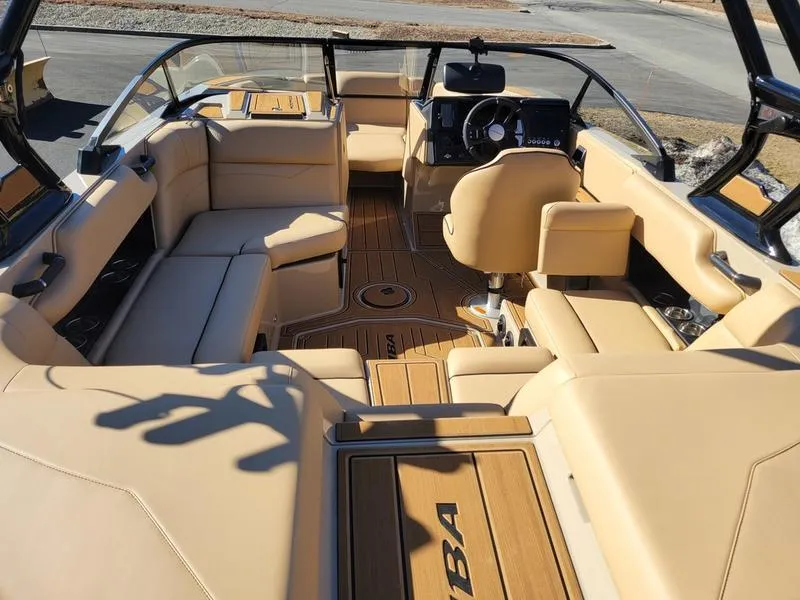 Slide: The Image of 2024 Moomba Mondo boat interior with beige seating and modern dashboard. - 9