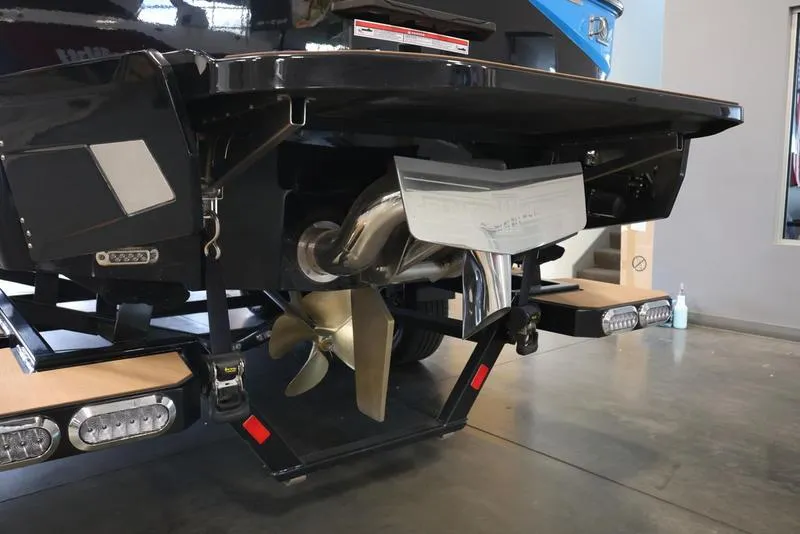 Slide: The Image of 2024 Axis T250 boat stern with propeller and underwater lights in a showroom. - 11