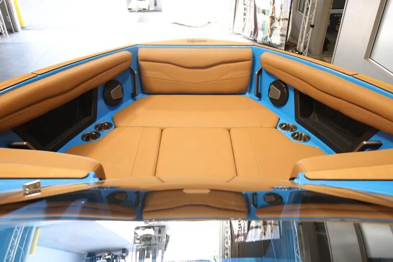 Slide: The Image of 2024 Axis T250 boat interior with tan leather seating and blue accents. - 16