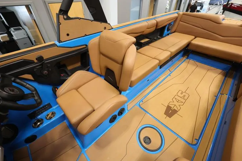 Slide: The Image of 2024 Axis T250 boat interior with tan seats and blue accents. - 17