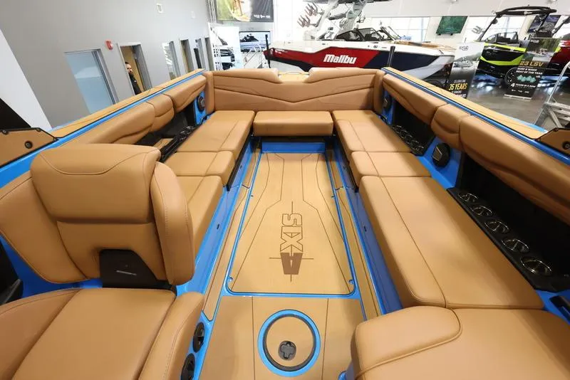 Slide: The Image of 2024 Axis T250 boat interior with tan leather seating and blue accents. - 3