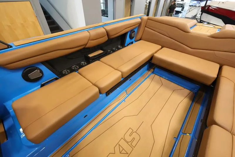 Slide: The Image of 2024 Axis T250 boat interior with tan leather seating and blue accents. - 5