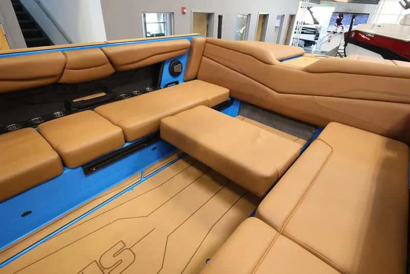 Slide: The Image of 2024 Axis T250 boat interior with tan leather seating and blue accents. - 7