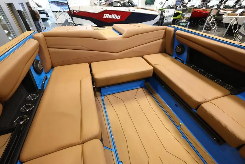 Slide: The Image of 2024 Axis T250 boat interior with tan leather seating and blue accents. - 8
